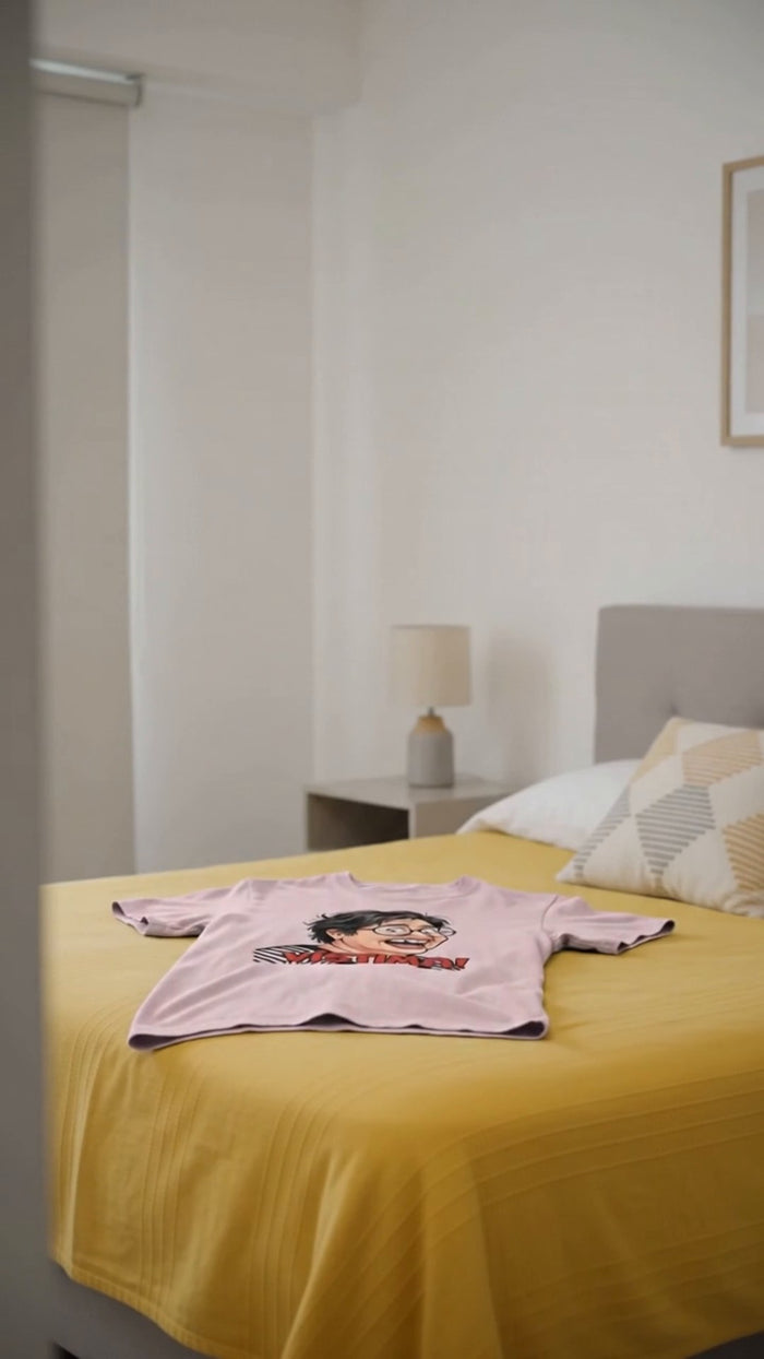 Polera rosada Vístima sobre una cama